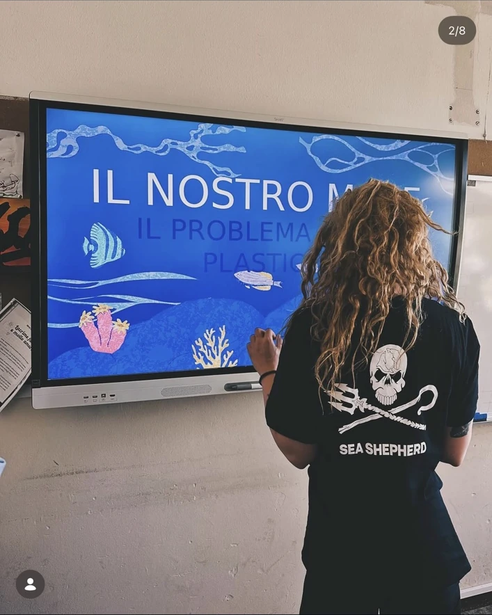 Camilla speaking to students about plastic pollution wearing Sea Shepherd